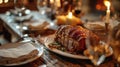 Roasted pork loin on a festive table with candles and wine