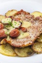 roasted pork meat with sausage, mustard sauce and roasted potatoes Royalty Free Stock Photo