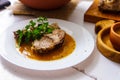 Roasted pork neck on a plate. Appetizing dish on the wooden table.