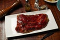 Roasted Pork Rib with Secret Sauce BBQ Spare Ribs served in dish isolated on wooden table top view of italian fast food Royalty Free Stock Photo