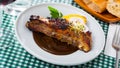 Roasted pork ribs in chocolate sauce with baked potatoes Royalty Free Stock Photo