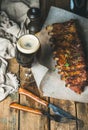 Roasted pork ribs with garlic, rosemary and glass of beer
