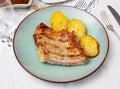 Roasted pork ribs with side dish of fried potatoes Royalty Free Stock Photo