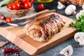 Roasted pork roll stuffed mushrooms and cheese on a board Royalty Free Stock Photo