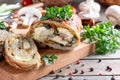 Roasted pork roll stuffed with mushrooms and cheese served with vegetables on a board Royalty Free Stock Photo