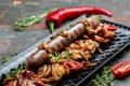 Roasted Potato and Sausage Dinner, cut into slices and fried in oil, served with chili peppers and mustard on a wooden background Royalty Free Stock Photo