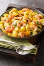 Roasted potatoes with garlic, herbs and shrimp close-up in a plate. Vertical Royalty Free Stock Photo