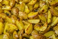 Roasted potatoes in a rustic backgarund. Slices of rustic fried potatoes with spices Royalty Free Stock Photo