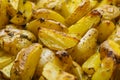 Roasted potatoes in a rustic backgarund. Slices of rustic fried potatoes with spices Royalty Free Stock Photo