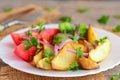 Roasted potatoes and vegetables. Roasted potato wedges, boiled broccoli, fresh tomato slices, red onion, green parsley