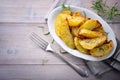 Roasted potatoes with fork on wooden background, space for text. Royalty Free Stock Photo