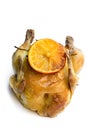 Roasted poussin with orange and rosemary isolated on white