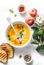 Roasted pumpkin and apples vegetarian soup on light background, top view. Flat lay. Healthy vegetarian food Royalty Free Stock Photo