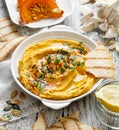 Roasted pumpkin hummus, creamy and delicious dip on a white plate Royalty Free Stock Photo