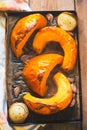 Roasted pumpkin with onion and garlic on baking tray. Preparing pumpkin soup Royalty Free Stock Photo