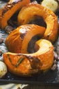 Roasted pumpkin with onion and garlic on baking tray. Preparing pumpkin soup Royalty Free Stock Photo