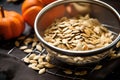 roasted pumpkin seeds in a mesh sieve