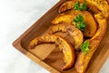 Roasted pumpkin slices on wooden tray