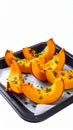 Roasted Pumpkin Wedges on Baking Sheet with Herbs Isolated on White Royalty Free Stock Photo