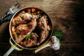 Roasted Rabbit Haunch in Pan on Rustic Wood Table