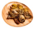 Roasted rabbit pieces with vegetable garnish of fried potatoes Royalty Free Stock Photo