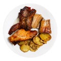 Roasted rabbit pieces with vegetable garnish of fried potatoes Royalty Free Stock Photo