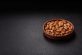 Roasted or raw almond nuts in shell in bowl Royalty Free Stock Photo