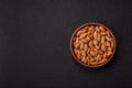 Roasted or raw almond nuts in shell in bowl Royalty Free Stock Photo
