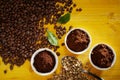 Roasted and raw coffee beans with grounds Royalty Free Stock Photo