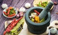 Roasted Red orange and green chili Peppers in pestle Royalty Free Stock Photo