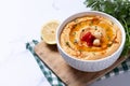Roasted red pepper hummus in white bowl on white marble background Royalty Free Stock Photo