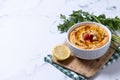 Roasted red pepper hummus in white bowl on white marble background Royalty Free Stock Photo