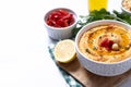 Roasted red pepper hummus in white bowl on white marble background Royalty Free Stock Photo