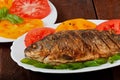 Roasted river fish carp on a white plate Royalty Free Stock Photo