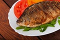 Roasted river fish carp on a white plate Royalty Free Stock Photo