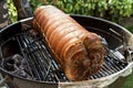 Roasted rolled pork cooking on the barbecue grill Royalty Free Stock Photo