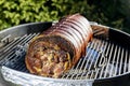 Roasted rolled pork cooking on the barbecue grill Royalty Free Stock Photo