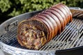 Roasted rolled pork cooking on the barbecue grill Royalty Free Stock Photo