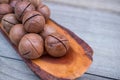 Roasted and salted macadamia nuts on rustic wooden background. Copy space Royalty Free Stock Photo