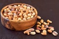 Roasted salted mixed nuts in wooden bowl. Closeup Royalty Free Stock Photo