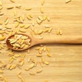 Roasted salted organic dry melon seeds, in wooden spoon on bamboo cutting board Royalty Free Stock Photo