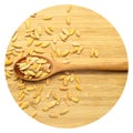 Roasted salted organic dry melon seeds, in wooden spoon on bamboo cutting board Royalty Free Stock Photo