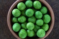 Roasted salted peanuts in a green crispy shell with wasabi flavor, closeup, top view. Food background. Snack to beer Royalty Free Stock Photo