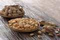 Roasted salted peanuts and Peanut peeled plate on wood table Royalty Free Stock Photo