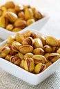 Roasted salted pistachios in a square bowls