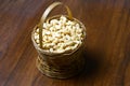 Roasted salted raw cashew nuts in wooden bowl on rustic table, healthy vegetarian snack, Anacardium occidentale, Cashews on white Royalty Free Stock Photo