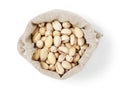 Roasted salty pistachios nuts in sack bag from above