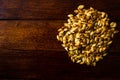 Roasted salty pumpkin seeds on wooden table