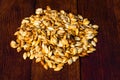 Roasted salty pumpkin seeds on wooden table