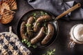 Roasted sausages in pan with bread herbs and draft beer. Royalty Free Stock Photo